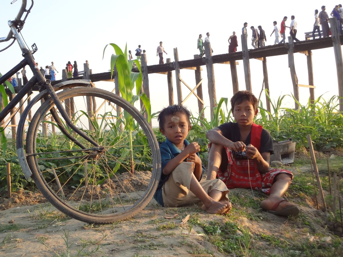 Boys resting at u Bein's bridge in Amarapura, Myanmar